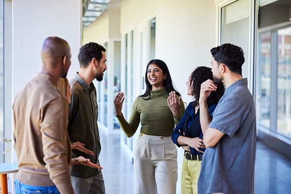 5 people standing in a hallway