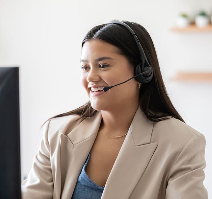 woman on headset working at computer